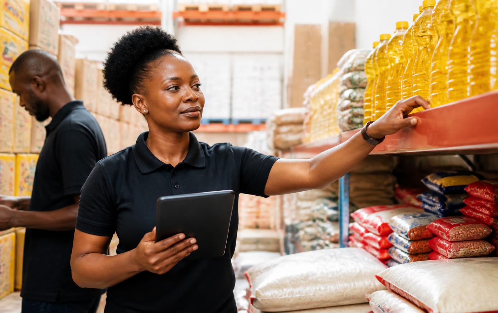 Verified supplier reviewing inventory in a warehouse